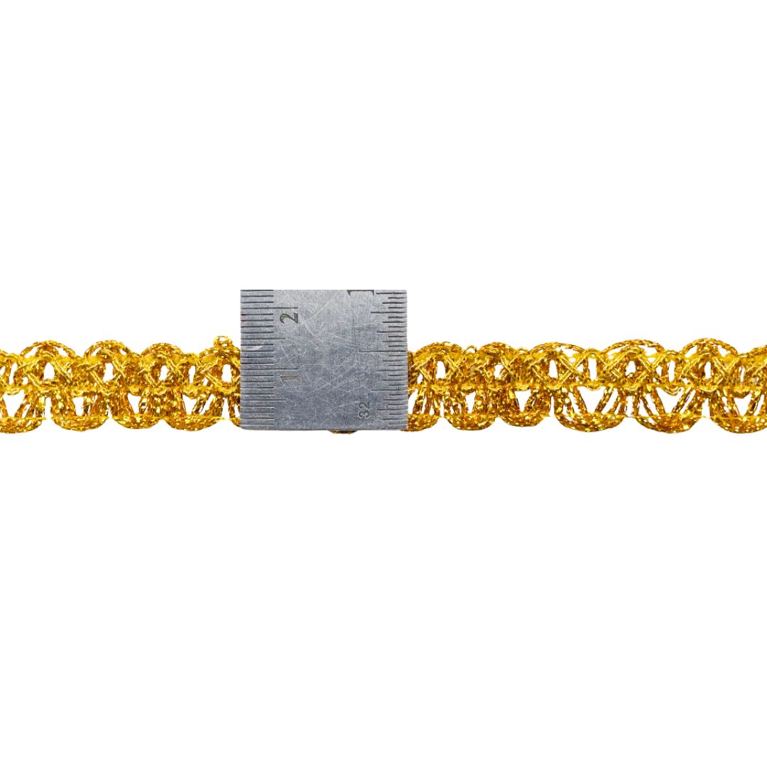 Gold chain with a small metal tool on a white background